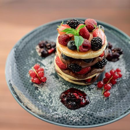 Address Istanbul Hotell Eksteriør bilde A stack of pancakes with fruit